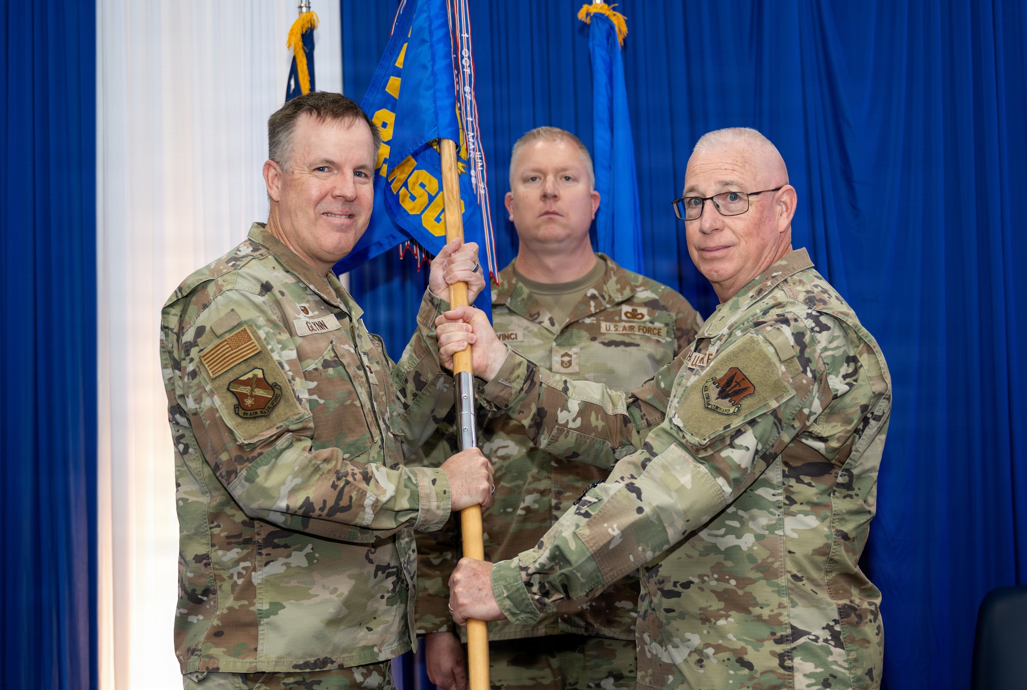 Two people holding guidon