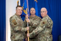 Two people holding guidon