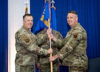 Two people holding guidon