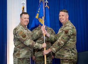 Two people holding guidon
