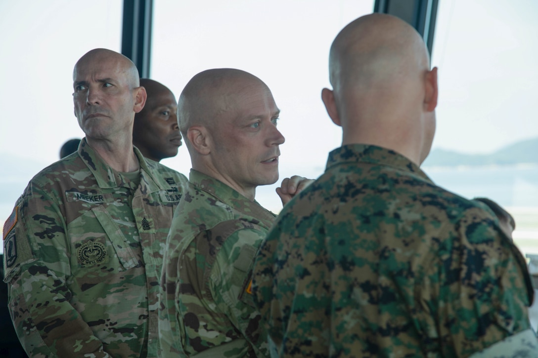 U.S. Marine Corps Col. Kenneth Rossman, right, the commanding officer of Marine Corps Air Station Iwakuni, and a native of Pittsburgh, Pennsylvania, gives a tour of the MCAS Iwakuni air traffic control tower to U.S. Army Command Sgt. Maj. Richard Meeker, left, the command sergeant major of U.S. Army Garrison Japan, and a native of Metropolis, Illinois, at MCAS Iwakuni, Japan, June 29, 2026. Davis and Meeker visited MCAS Iwakuni to meet with leaders, discuss combat readiness, and further strengthen teamwork between the U.S. Army and the U.S. Marine Corps in Japan. (U.S. Marine Corps photo by Lance Cpl. Gage Collins)