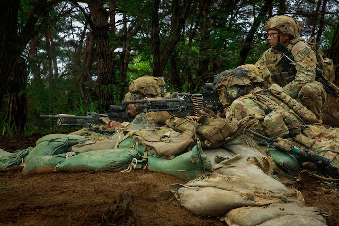 Soldiers assigned to Bravo Company, 4th Battalion, 23rd Infantry Regiment establish a support-by-fire position during platoon live fire exercises at Rodriguez live fire complex in South Korea, July 8, 2026.