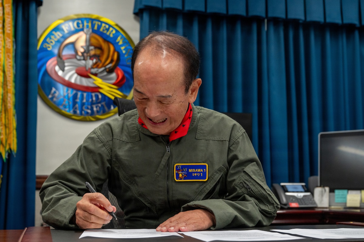 Misawa City Mayor Yoshinori Kohiyama signs official paperwork during a Wing Commander for a Day tradition at Misawa Air Base, Japan, July 1, 2026