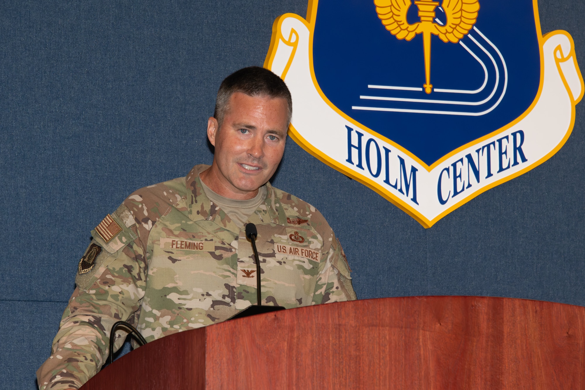 Colonel Fleming speaks at a podium during the ceremony