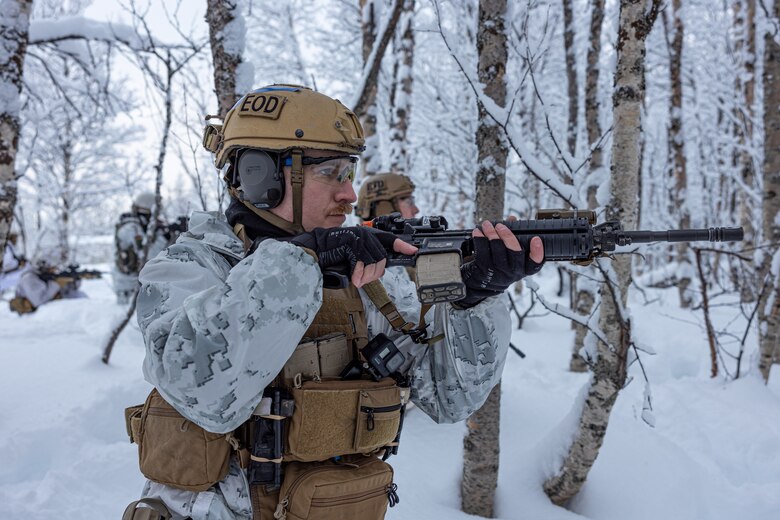 U.S. Marine Corps SSgt. Austin Vandervelde, an explosive ordinance technician with Marine Rational Force - Europe, provides security during a breaching and clearing  mission to display interoperability with allies and partner nations prior to Nordic Response 24 in Setermoen, Norway, Feb. 7, 2024. U.S. Marines, in collaboration with NATO allies and partners, gear up for the Nordic Response 24—a biennial NATO training exercise designed to advance arctic security, boost global readiness, and promote interoperability among U.S. Forces, Allied, and partner forces. (U.S. Marine Corps photo by Lance. Cpl. Christian Salazar)