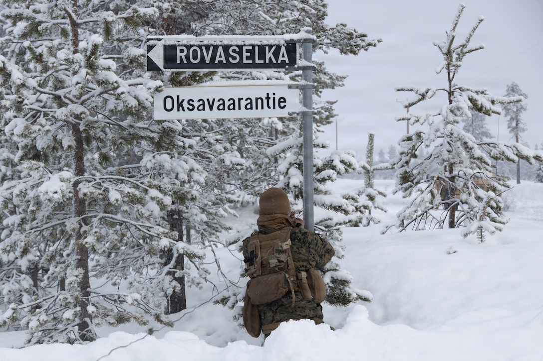 U.S. Marine Corps Isiah Alvarez, a transmissions systems operator with Combat Logistics Battalion 6, Combat Logistics Regiment 2, 2nd Marine Logistics Group, sets up a field expedient antenna underneath a road sign in Kamijarvi, Finland, March 16, 2026.  During exercise Cold Response 26, CLB-6 provided combat service support to 2nd Battalion, 6th Marine Regiment, 2nd Marine Division, including logistical resupplies and motorized heavy weapon support. This event marks one of the first times U.S. Marines have conducted this type of integrated infantry training with their Finnish counterparts since Finland joined the NATO Alliance. A key component of NATO's enhanced vigilance activity Arctic Sentry, exercise Cold Response 26 is a Norwegian-led winter military exercise designed to enhance collective defense capabilities and ensure U.S. readiness to rapidly deploy and seamlessly operate alongside NATO Allies in challenging arctic conditions. (U.S. Marine Corps photo by Cpl. Apollo Wilson)
