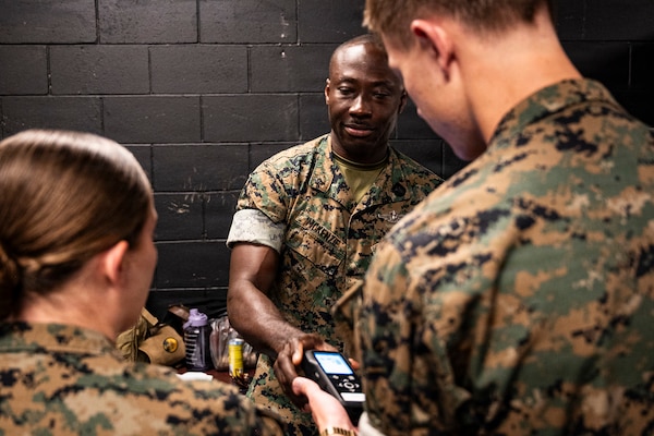 U.S. Navy corpsmen and medical officers from across the II Marine Expeditionary Force get hands-on with a TBI assessment device during an end-user touchpoint at the Tactical Medicine Training Center, Camp Lejeune, North Carolina, June 30, 2026. The event brought together U.S. Navy corpsmen and medical officers from across the II Marine Expeditionary Force to assess new capabilities for evaluating traumatic brain injuries on the battlefield. Participants evaluated Traumatic Brain Injury Field Assessment Program devices in a hands-on session, giving TBI-FAP developers critical feedback directly from the frontline medical providers who may one day use the equipment in austere environments. (Defense Health Agency Photo by T. T. Parish/Released)