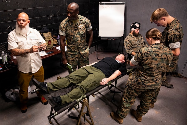 U.S. Navy corpsmen and medical officers from across the II Marine Expeditionary Force get hands-on with a TBI assessment device during an end-user touchpoint at the Tactical Medicine Training Center, Camp Lejeune, North Carolina, June 30, 2026. The event brought together U.S. Navy corpsmen and medical officers from across the II Marine Expeditionary Force to assess new capabilities for evaluating traumatic brain injuries on the battlefield. Participants evaluated Traumatic Brain Injury Field Assessment Program devices in a hands-on session, giving TBI-FAP developers critical feedback directly from the frontline medical providers who may one day use the equipment in austere environments. (Defense Health Agency Photo by T. T. Parish/Released)