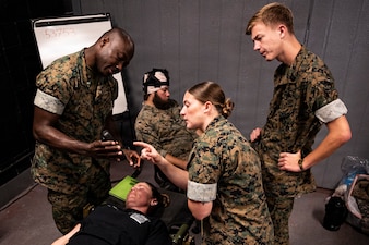 U.S. Navy corpsmen and medical officers from across the II Marine Expeditionary Force get hands-on with a TBI assessment device during an end-user touchpoint at the Tactical Medicine Training Center, Camp Lejeune, North Carolina, June 30, 2026. The event brought together U.S. Navy corpsmen and medical officers from across the II Marine Expeditionary Force to assess new capabilities for evaluating traumatic brain injuries on the battlefield. Participants evaluated Traumatic Brain Injury Field Assessment Program devices in a hands-on session, giving TBI-FAP developers critical feedback directly from the frontline medical providers who may one day use the equipment in austere environments. (Defense Health Agency Photo by T. T. Parish/Released)