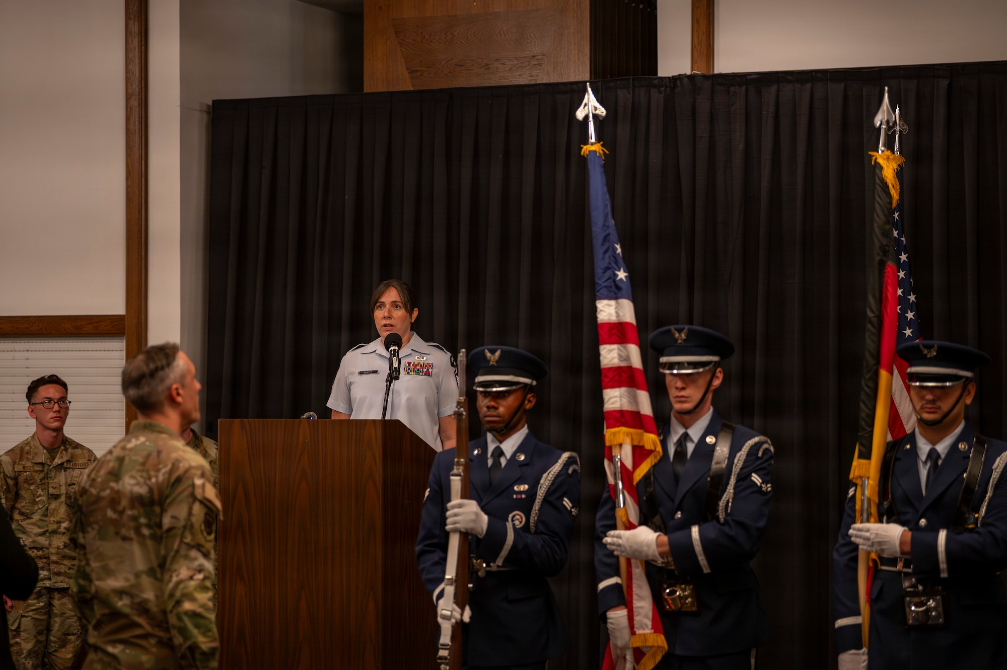 A photo of an Airman singing the Star-Spangled Banner at a change of command ceremony