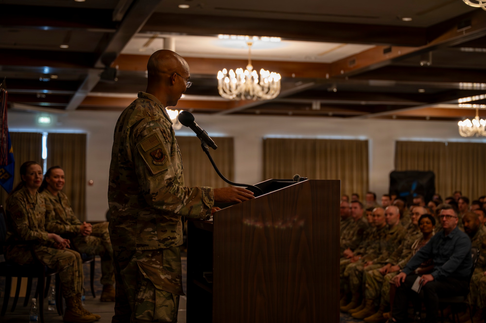 A photo of an Airman speaking in front of a crowd at a change of command ceremony