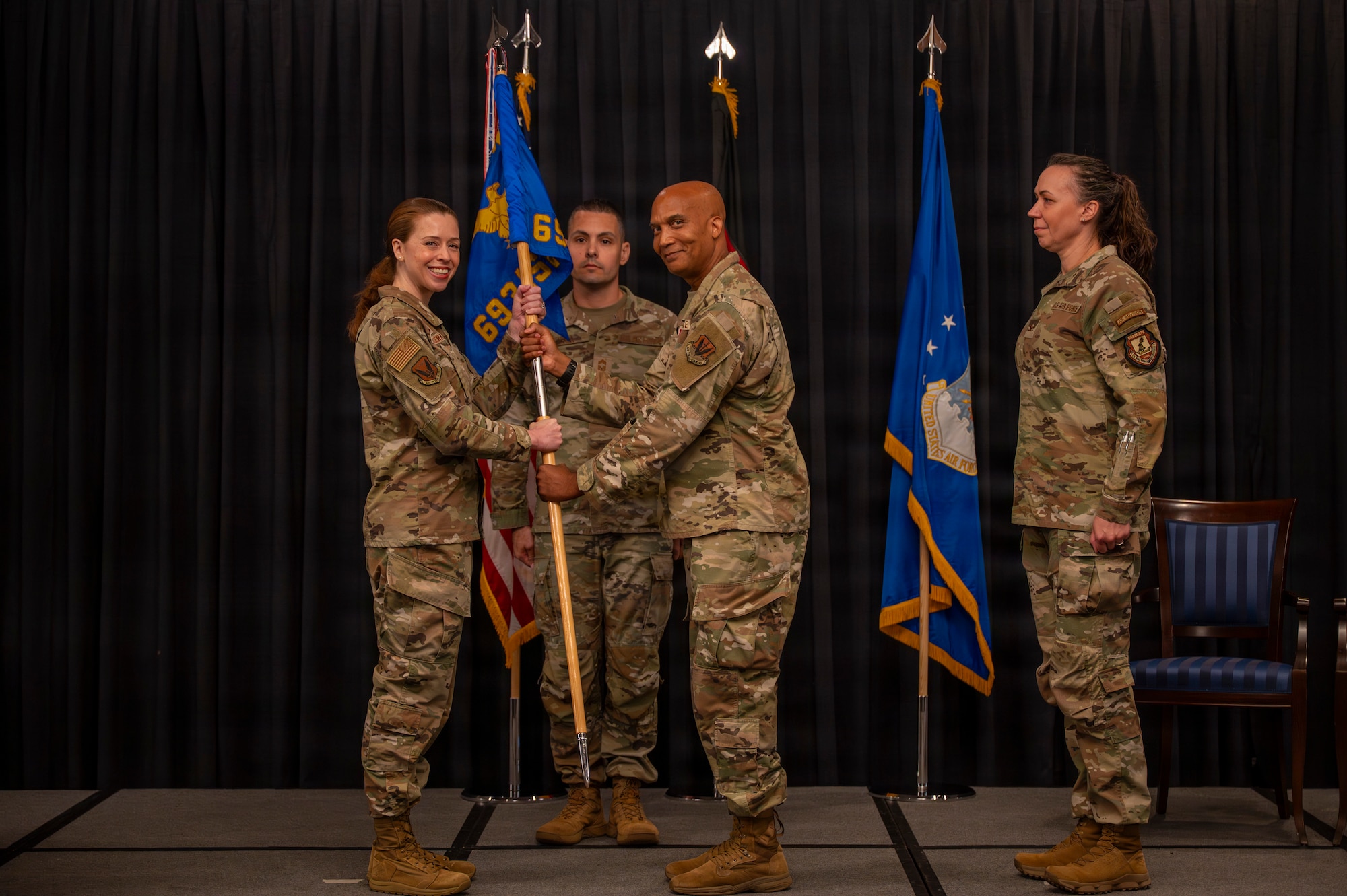 A photo of Airmen exchanging a guidon