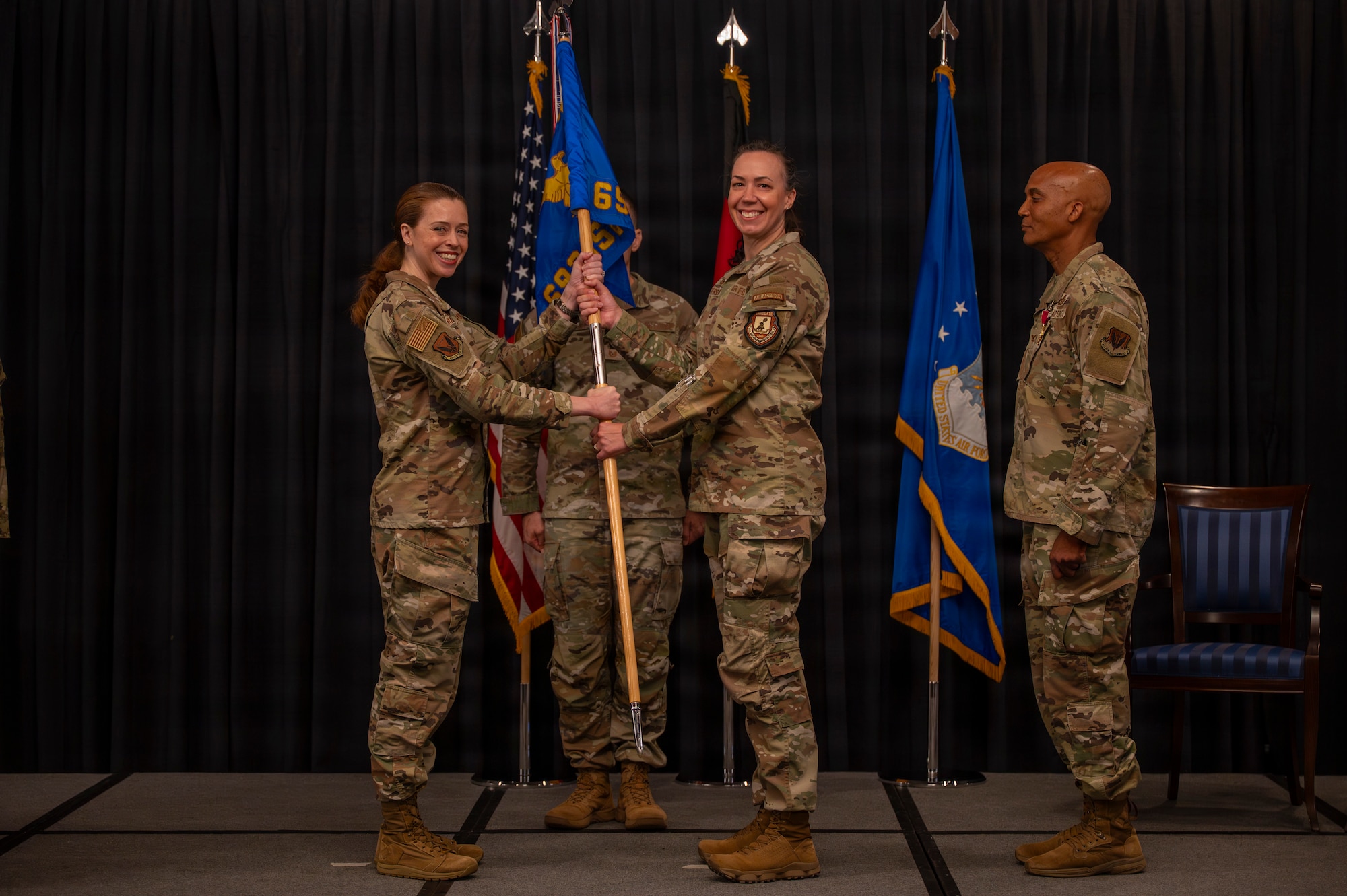 A photo of Airmen exchanging the guidon