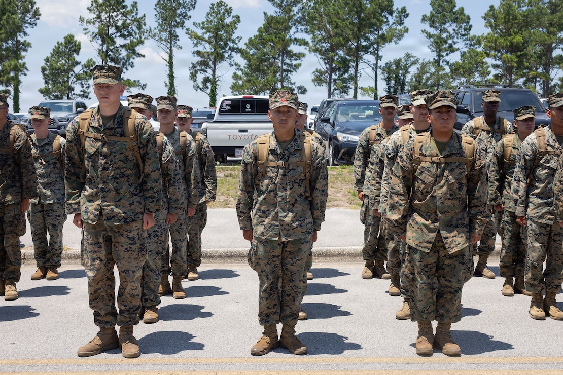 U.S. Marines and Sailors with Combat Logistics Battalion 24, Combat Logistics Regiment 27, 2nd Marine Logistics Group, stand at attention during a homecoming event at Marine Corps Base Camp Lejeune, North Carolina, June 9, 2026. CLB-24 arrived after completing exercises Aurora 26 and Baltic Operations 26, which supported NATO's Eastern Flank Deterrence Initiative and strengthened combined readiness in the Baltic Sea region. (U.S. Marine Corps photo by Lance Cpl. Isabelle Veillette)