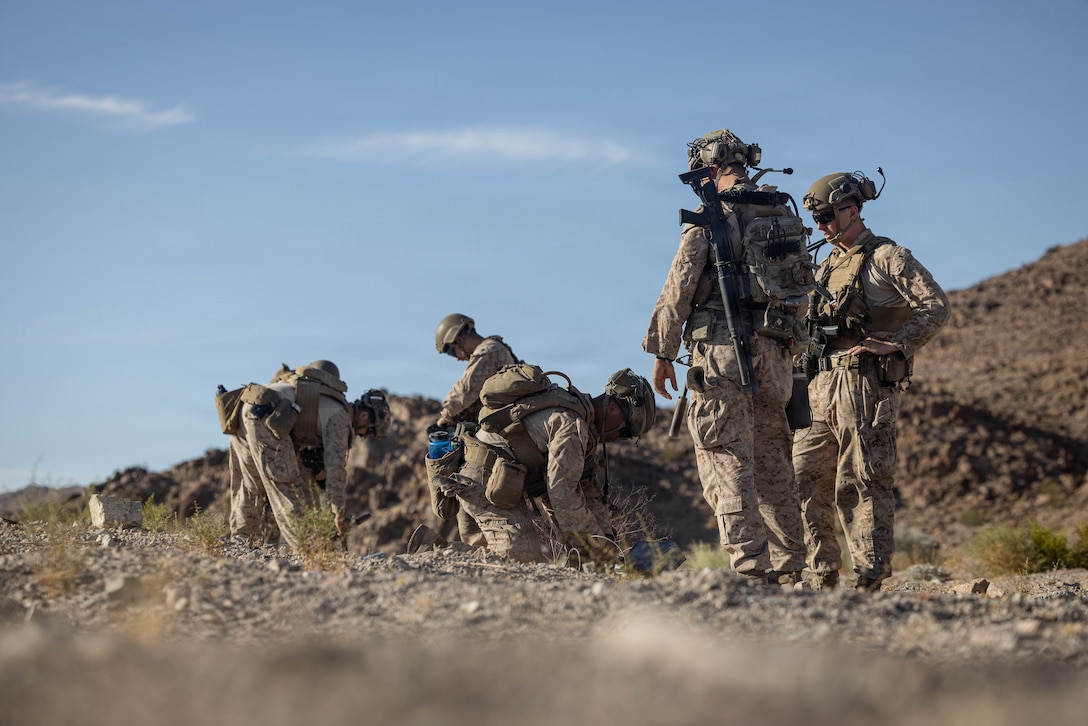 U.S. Marines with 2nd Combat Engineer Battalion, 2nd Marine Division, place charges at Range 114 during Service Level Training Exercise 4-26 on Marine Corps Air Ground Combat Center, Twentynine Palms, California, July 11, 2026. SLTE 4-26 is designed to be a challenging, realistic training environment that produces combat-ready forces capable of operating as an integrated Marine Air Ground Task Force across all domains of military operations. (U.S. Marine Corps photo by Sgt. Alexis French)