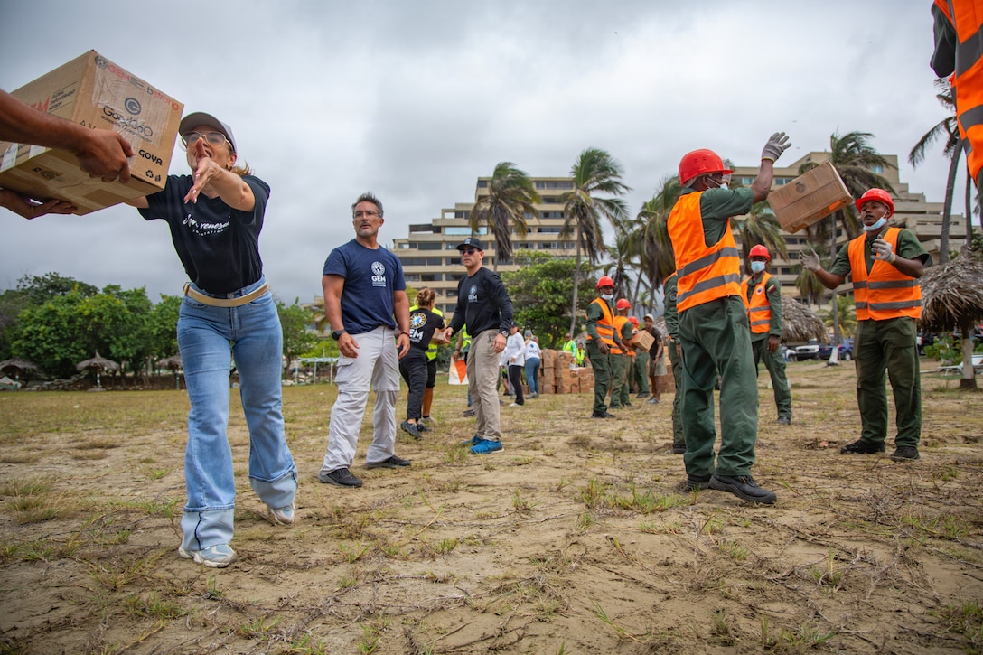 Members of Global Empowerment Mission, left, and Venezuelan service members assist U.S. Marines with Littoral Combat Force-24, and U.S. Sailors with San Antonio-class amphibious transport dock USS San Antonio (LPD 17), offload disaster assistance supplies at La Guaira, Venezuela, July 11, 2026. At the direction of U.S. Southern Command, assigned U.S. military forces are supporting Department of State-led U.S. disaster assistance to the people of Venezuela in the aftermath of the June 24, 2026, earthquakes. (U.S. Marine Corps photo)