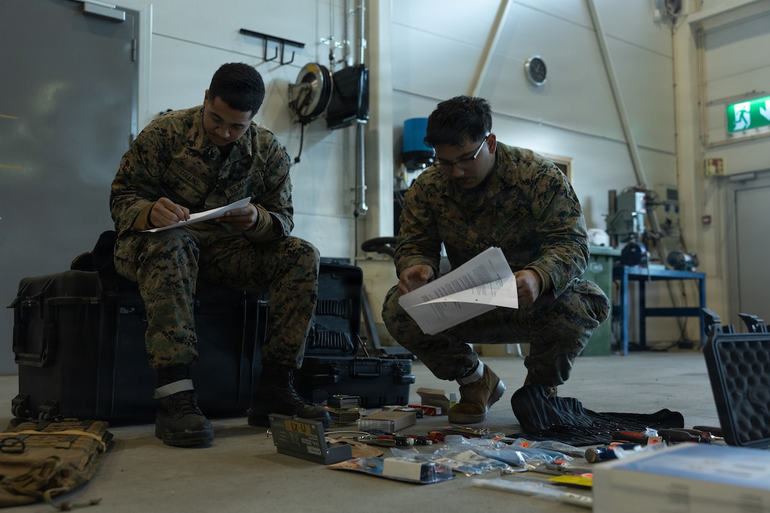 U.S. Marine Corps Cpl. Troy Collins, left, a utilities systems technician with Headquarters Battalion, 2nd Marine Division, II Marine Expeditionary Force, and Cpl. Joseph Spencer, a maintenance management specialist with Marine Wing Support Squadron 273, Marine Air Control Group 28, 2nd Marine Aircraft Wing, inspect supplies during cave draw operations in preparation for exercise Cold Response 26 in Tromsdalen, Norway, Jan. 22, 2026. The Marine Corps Pre-positioning Program-Norway, managed by Blount Island Command, enables the rapid outfitting of a deployed Marine Air-Ground Task Force by storing ready-to-use equipment in climate-controlled caves. Exercise Cold Response 26 is a Norwegian-led winter military exercise designed to enhance collective defense capabilities and ensure U.S. readiness to rapidly deploy and seamlessly operate alongside NATO Allies in challenging arctic conditions. Collins is a native of Texas, and Spencer is a native of Nevada. (U.S. Marine Corps photo by Lance Cpl. Franco Lewis)