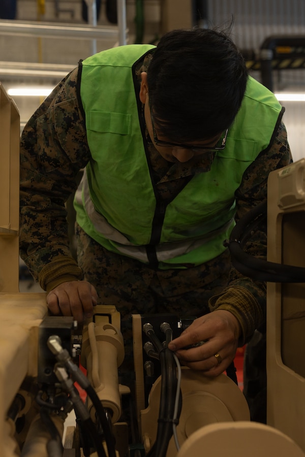 U.S. Marine Corps Lance Cpl. Ronny LimaFernandez, an engineer equipment mechanic with Marine Wing Support Squadron 273, Marine Air Control Group 28, 2nd Marine Aircraft Wing, inspects a modernized Extended Boom Forklift during cave draw operations in preparation for exercise Cold Response 26 in Tromsdalen, Norway, Jan. 22, 2026. The Marine Corps Pre-positioning Program-Norway, managed by Blount Island Command, enables the rapid outfitting of a deployed Marine Air-Ground Task Force by storing ready-to-use equipment in climate-controlled caves. Exercise Cold Response 26 is a Norwegian-led winter military exercise designed to enhance collective defense capabilities and ensure U.S. readiness to rapidly deploy and seamlessly operate alongside NATO Allies in challenging arctic conditions. LimaFernandez is a native of New Jersey. (U.S. Marine Corps photo by Lance Cpl. Franco Lewis)