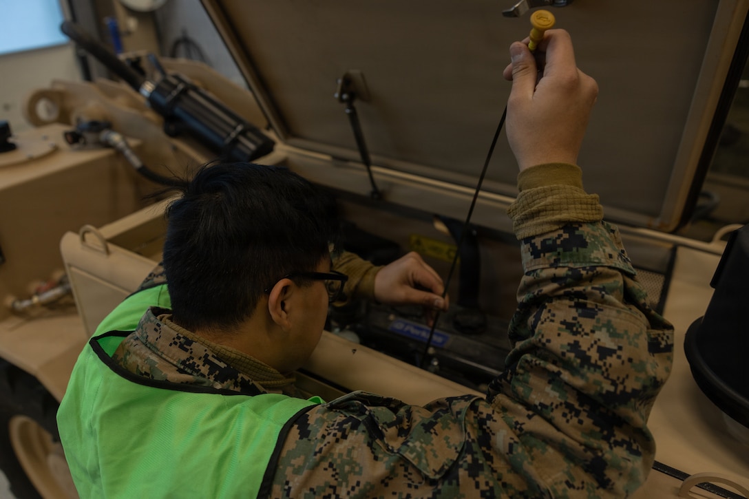 U.S. Marine Corps Lance Cpl. Ronny LimaFernandez, an engineer equipment mechanic with Marine Wing Support Squadron 273, Marine Air Control Group 28, 2nd Marine Aircraft Wing, inspects the oil of a modernized Extendable Boom Forklift during cave draw operations in preparation for exercise Cold Response 26 in Tromsdalen, Norway, Jan. 22, 2026. The Marine Corps Pre-positioning Program-Norway, managed by Blount Island Command, enables the rapid outfitting of a deployed Marine Air-Ground Task Force by storing ready-to-use equipment in climate-controlled caves. Exercise Cold Response 26 is a Norwegian-led winter military exercise designed to enhance collective defense capabilities and ensure U.S. readiness to rapidly deploy and seamlessly operate alongside NATO Allies in challenging arctic conditions. LimaFernandez is a native of New Jersey. (U.S. Marine Corps photo by Lance Cpl. Franco Lewis)