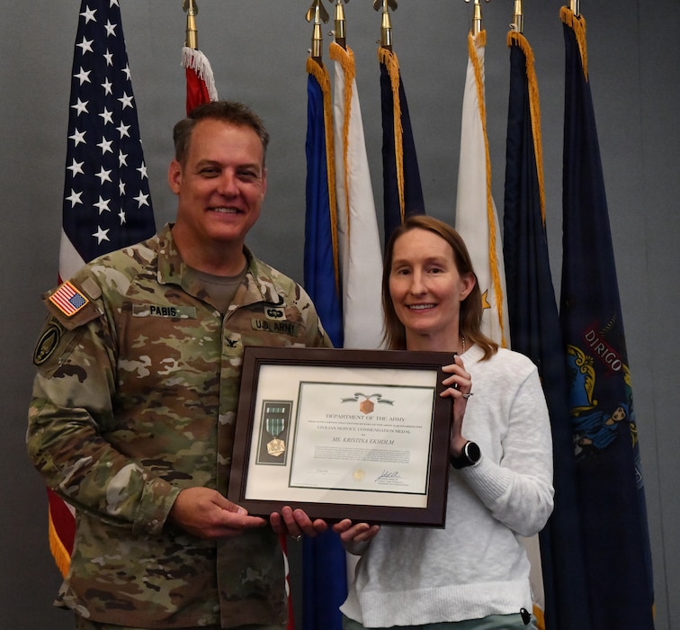 Colonel Justin R. Pabis, New England District Commander, presents Kristine Ekholm the Civilian Service Commendation Medal and a Bunker Hill plaque for her nomination for the Hydrology/Hydraulics & Coastal Professional of the Year during the District's Founder's Day celebration, June 26, 2026.