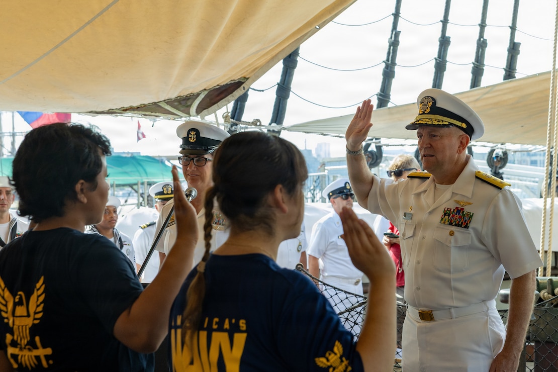 U.S. Navy Rear Adm. David Faehnle, commandant, Naval District Washington gives the Oath of Enlistment to future sailors aboard the USS Constellation in Baltimore