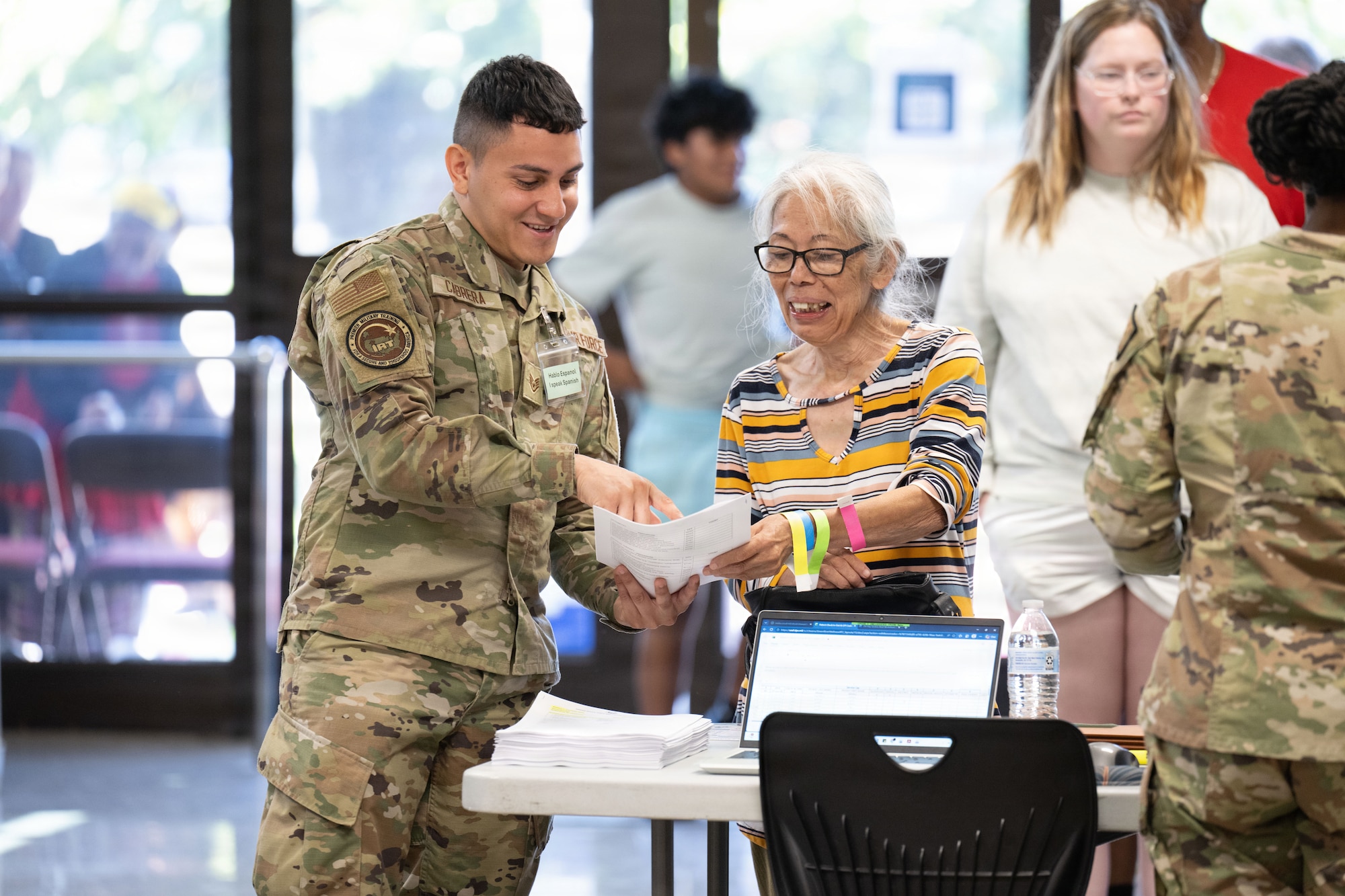 U.S. Air Force Staff Sgt. Hector Cabrera, left, assists a community member during the Green River Area Wellness Innovative Readiness Training mission, June 17, 2026