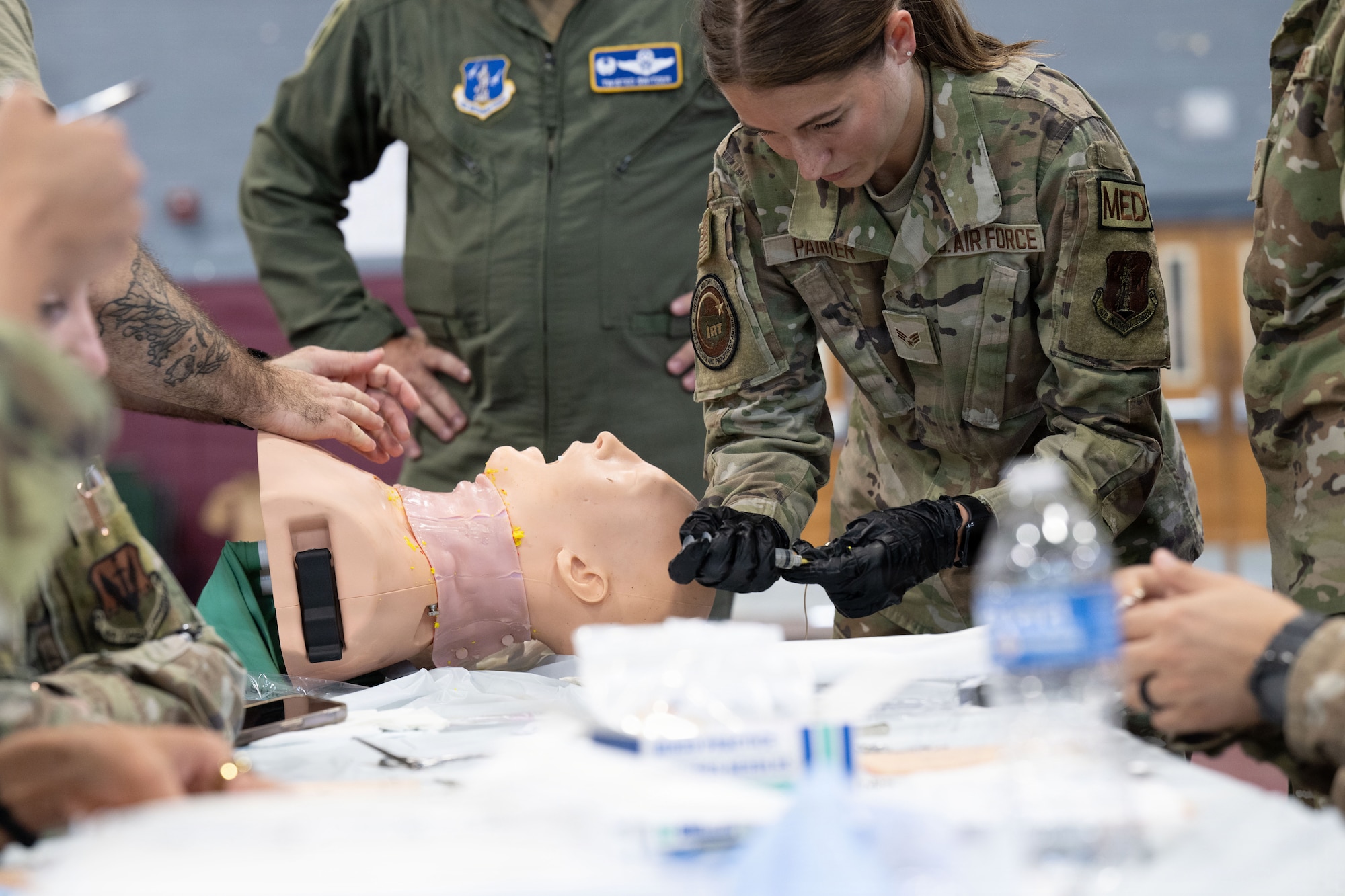 U.S. Air Force SrA Tamara Painter, practices performing a tracheostomy at the Green River Area Wellness Innovative Readiness Training mission