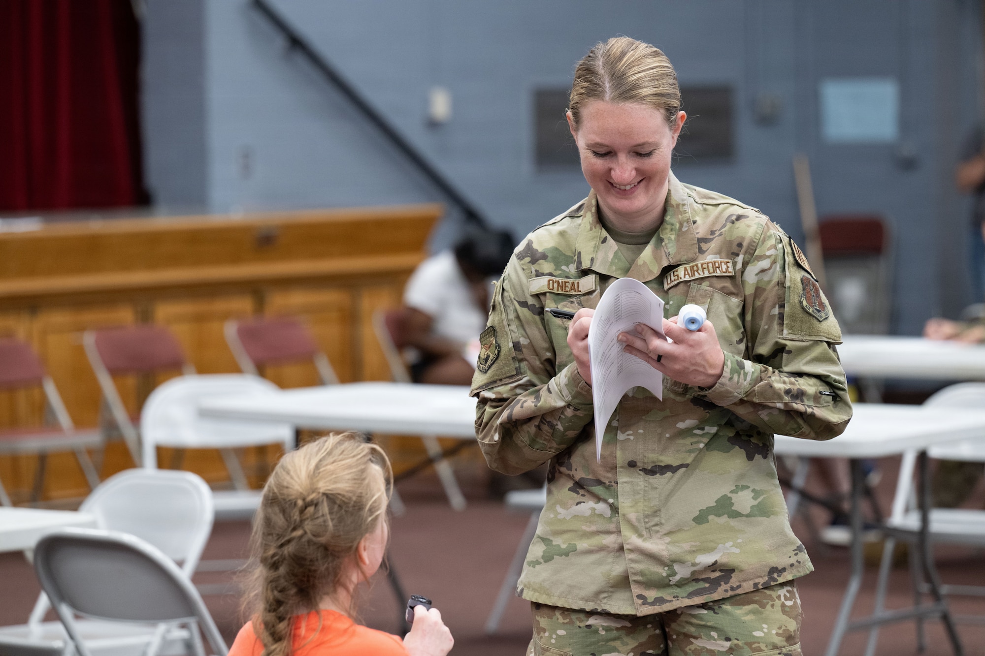 U.S. Air Force Tech Sgt. Hector Cabrera, checks the temperature of a community member during the Green River Area Wellness Innovative Readiness Training mission