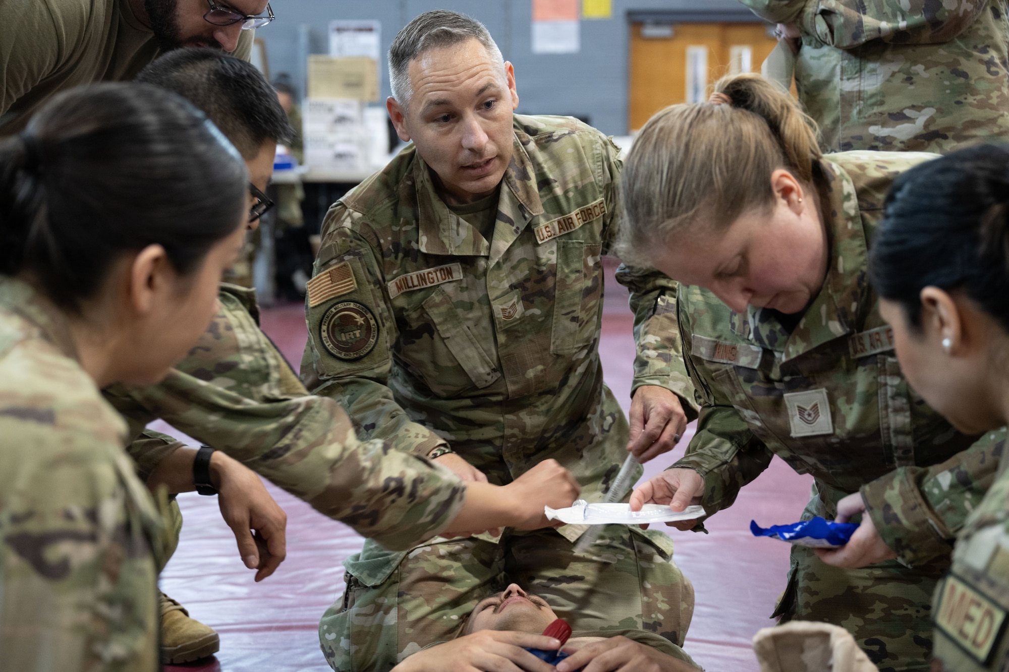 U.S. Air Force Tech. Sgt. Dustin Millington, center, leads a team through medical training at the Green River Area Wellness Innovative Readiness Training mission,