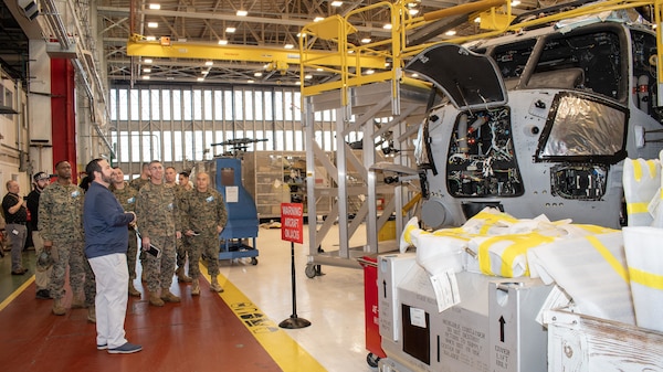 Fleet Readiness Center East (FRCE) Planning and Operations Division Director Michael Wagoner stops at a CH-53K King Stallion undergoing maintenance as he leads a group of Marines from the 2nd Marine Logistics Group (2nd MLG) at Camp Lejeune, N.C., on a tour of the depot’s H-53 aircraft production line Feb. 12.