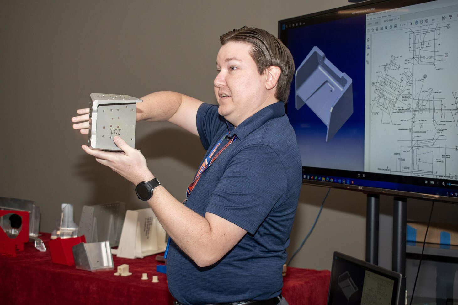 Jason Jarnagan, lead engineer in the Fleet Readiness Center East (FRCE) Digital Data Center, explains to Marines from the 2nd Marine Logistics Group (2nd MLG) at Camp Lejeune, N.C., how a cross-disciplinary group of engineers and artisans works together to produce a fixture using advanced manufacturing techniques.