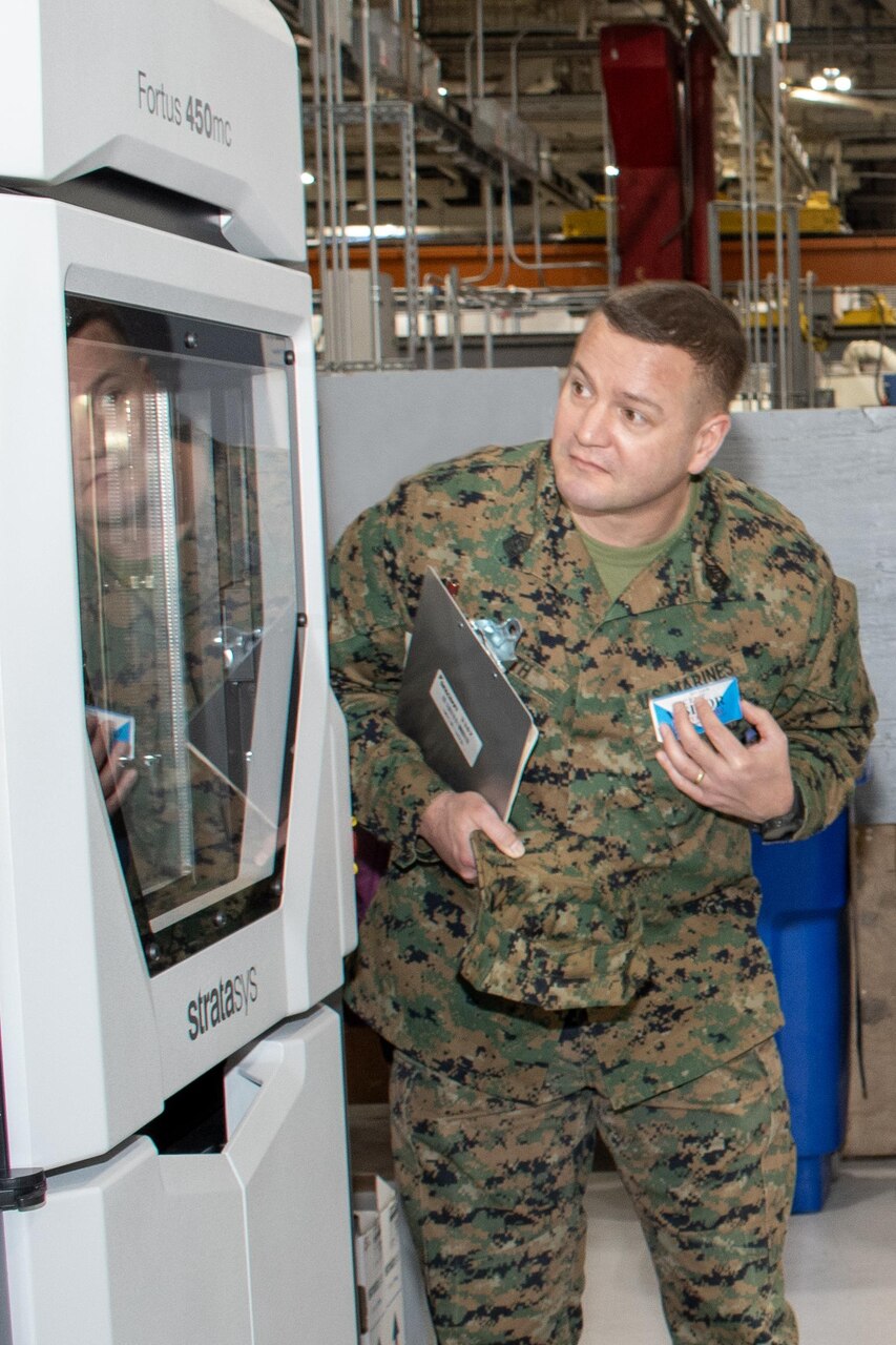 Master Gunnery Sgt. David Smith, a Marine with 2nd Marine Logistics Group (2nd MLG) at Camp Lejeune, N.C., checks out a 3D printer at Fleet Readiness Center East (FRCE) facilities onboard Marine Corps Air Station Cherry Point, N.C., Feb. 12.