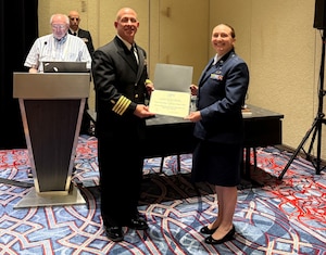 Capt. Gabrielle Baugh accepts the Young Health Physicist of the Year Award