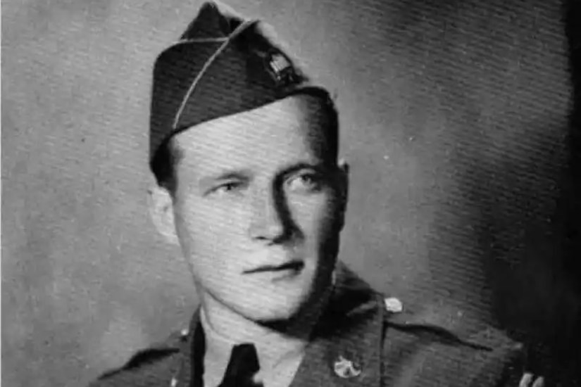 A man wearing a military dress uniform poses for a photo.