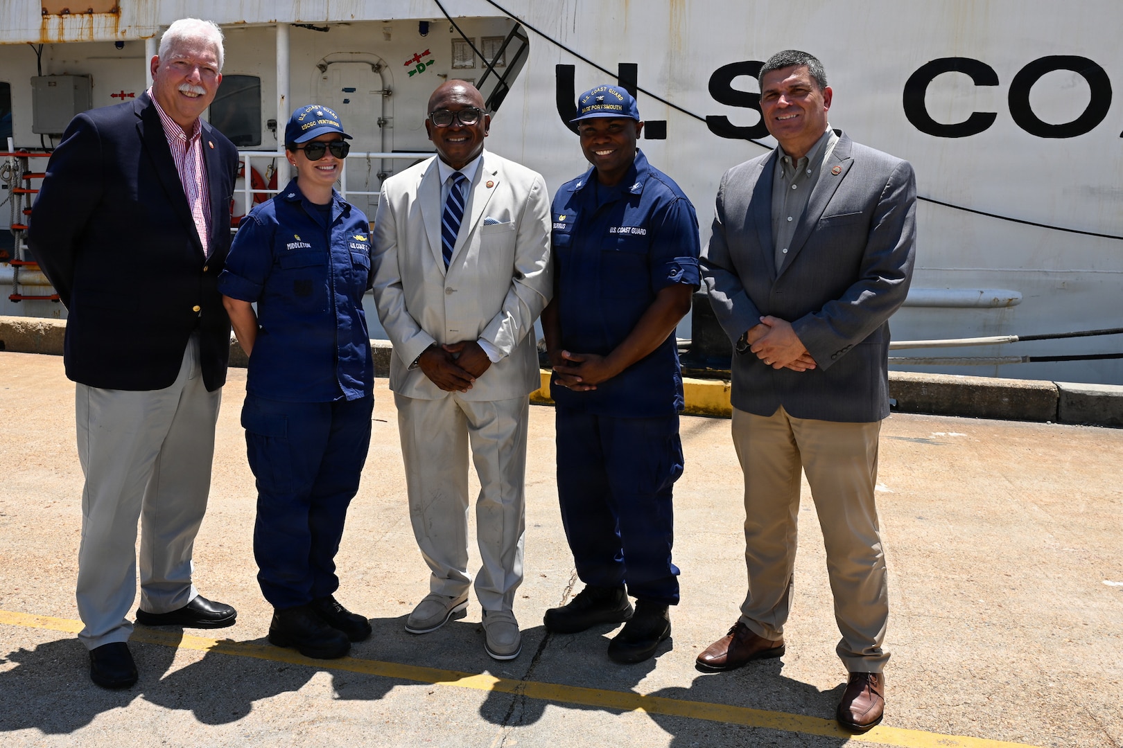 Portsmouth Mayor Shannon Glover, center, poses for a photo with the command of the Reliance-class medium-endurance cutter USCGC Venturous (WMEC 625) and Coast Guard Base Portsmouth, July 10, 2026. The Venturous is one of two 210-foot medium endurance cutters relocating from St. Petersburg, Florida, to Base Portsmouth as part of a strategic homeport shift bringing approximately 154 personnel and their families to the Hampton Roads area. (U.S. Coast Guard photo by Petty Officer 2nd Class Kate Kilroy)