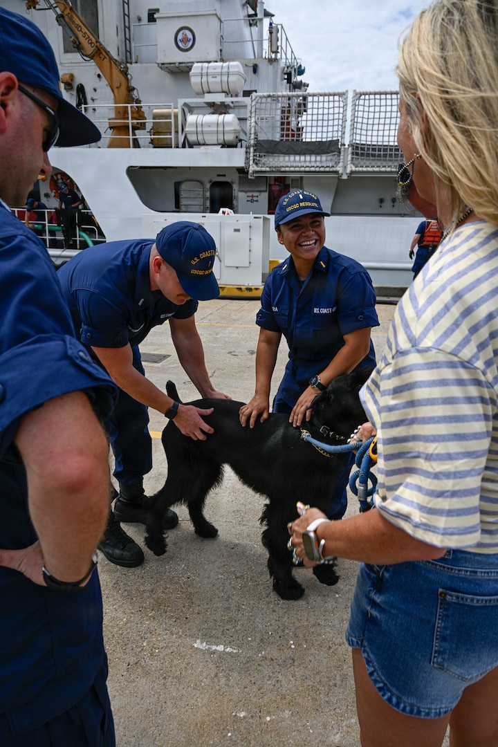 Friends and family members greet crew members of the Reliance-class medium-endurance cutter USCGC Resolute (WMEC 620) following the cutter's arrival at its new home port at Coast Guard Base Portsmouth, July 13, 2026. The Resolute is one of two 210-foot medium endurance cutters relocating from St. Petersburg, Florida, to Base Portsmouth as part of a strategic home port shift bringing approximately 154 personnel and their families to the Hampton Roads area. (U.S. Coast Guard photo by Petty Officer 2nd Class Kate Kilroy)