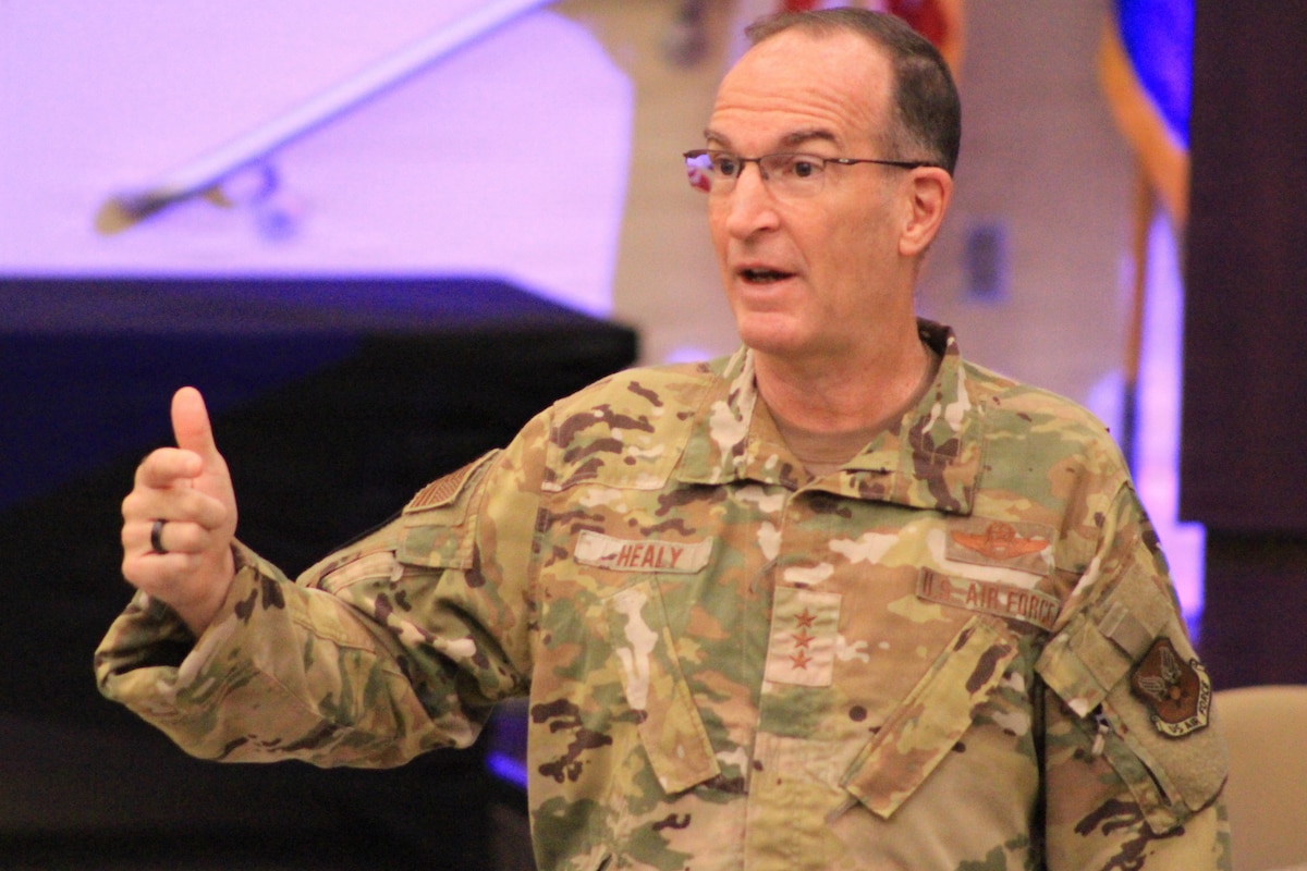 Service member talks to audience