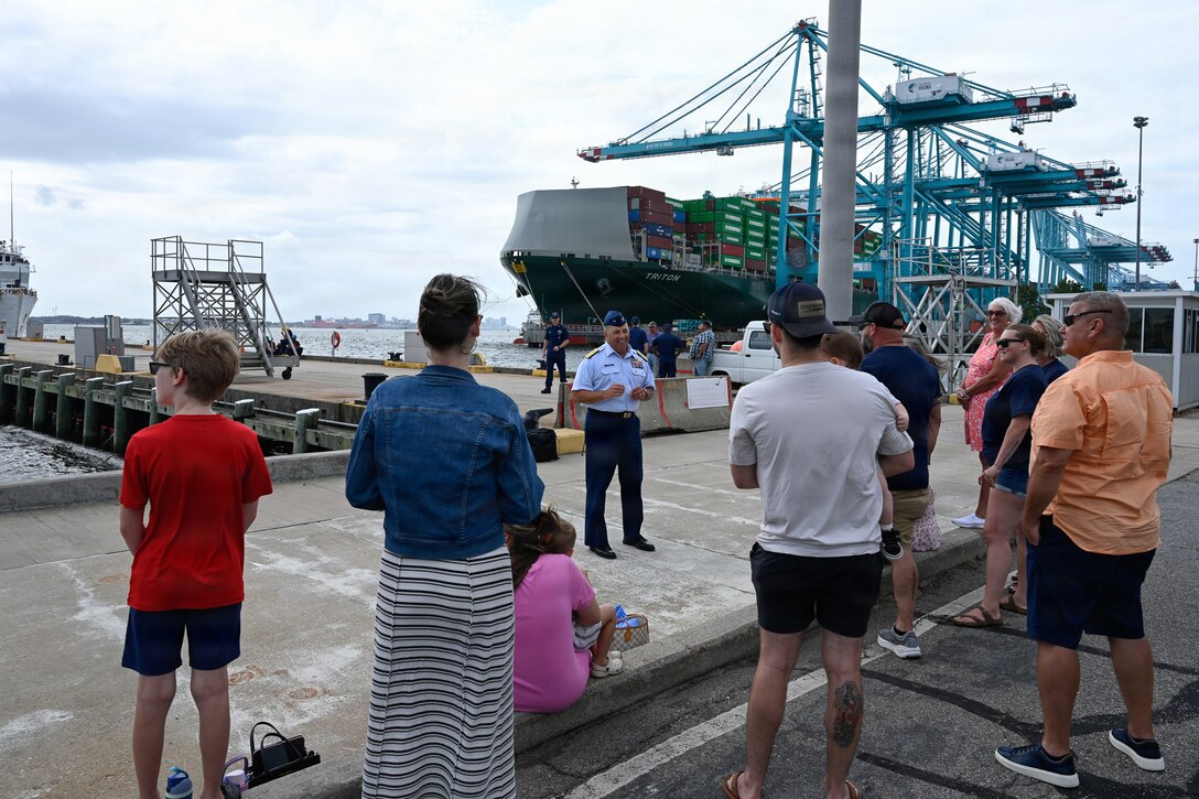 Coast Guard Rear Adm. Jay Vann, deputy commander of Coast Guard Atlantic Area, speaks with friends and family members of the Reliance-class medium-endurance cutter USCGC Resolute (WMEC 620) crew following the cutter's arrival at Coast Guard Base Portsmouth, July 13, 2026. The Resolute is one of two 210-foot medium endurance cutters relocating from St. Petersburg, Florida, to Base Portsmouth as part of a strategic home port shift bringing approximately 154 personnel and their families to the Hampton Roads area. (U.S. Coast Guard photo by Petty Officer 2nd Class Kate Kilroy)