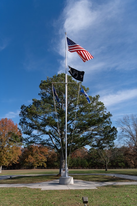 The American flag flies atop the pole in front of the Administration and Engineering Building at Arnold Air Force Base, Tenn., headquarters of Arnold Engineering Development Complex. The AEDC Safety team is encouraging team members to familiarize themselves with proper procedures when the music is played across the installation daily at 7:30 a.m. and 4:30 p.m. (U.S. Air Force photo by Keith Thornburgh)