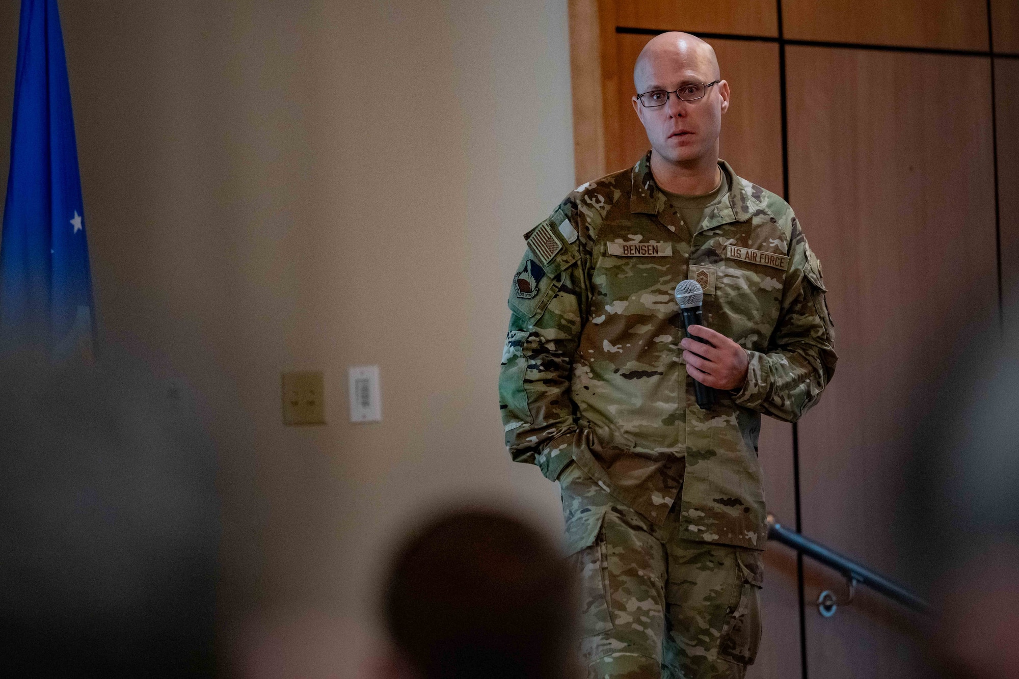 U.S. Air Force Chief Master Sgt. Erik Bensen, 325th Fighter Wing command chief, addresses Airmen during an all-call at Tyndall Air Force Base, Florida, July 14, 2026. During his remarks, Bensen highlighted his unique career path from the Army National Guard to the Air Force and emphasized the importance of professional mastery and looking out for fellow wingmen. (U.S. Air Force photo by Airman 1st Class Courtney McCants)