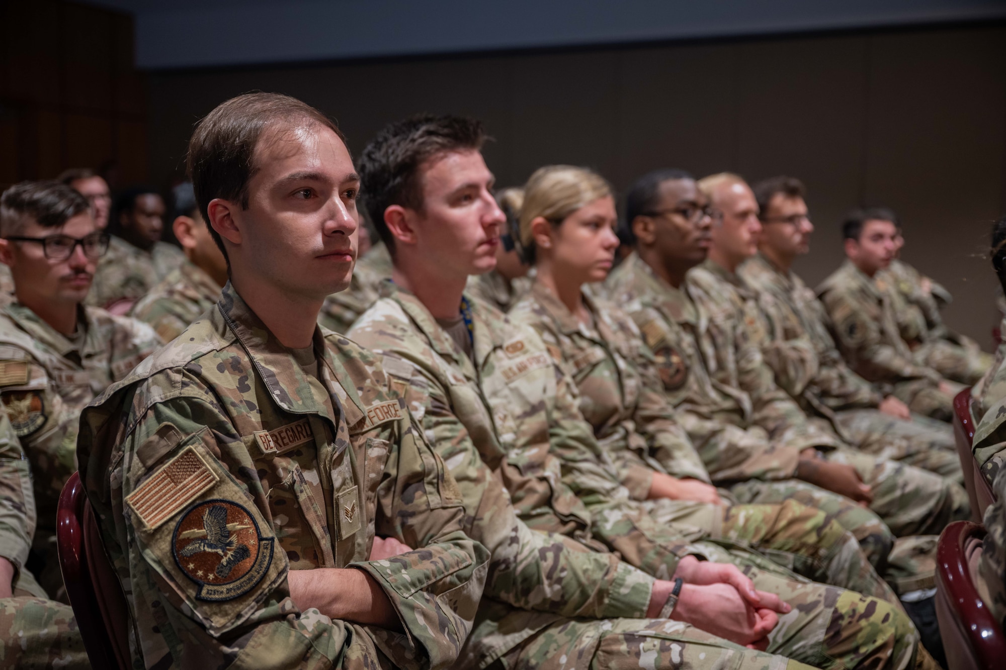 U.S. Airmen assigned to the 325th Fighter Wing listen during a wing all-call at Tyndall Air Force Base, Florida, July 14, 2026. The wing-wide event outlined leadership philosophies, strategic expectations and upcoming hurricane exercise operations. (U.S. Air Force photo by Airman 1st Class Courtney McCants)