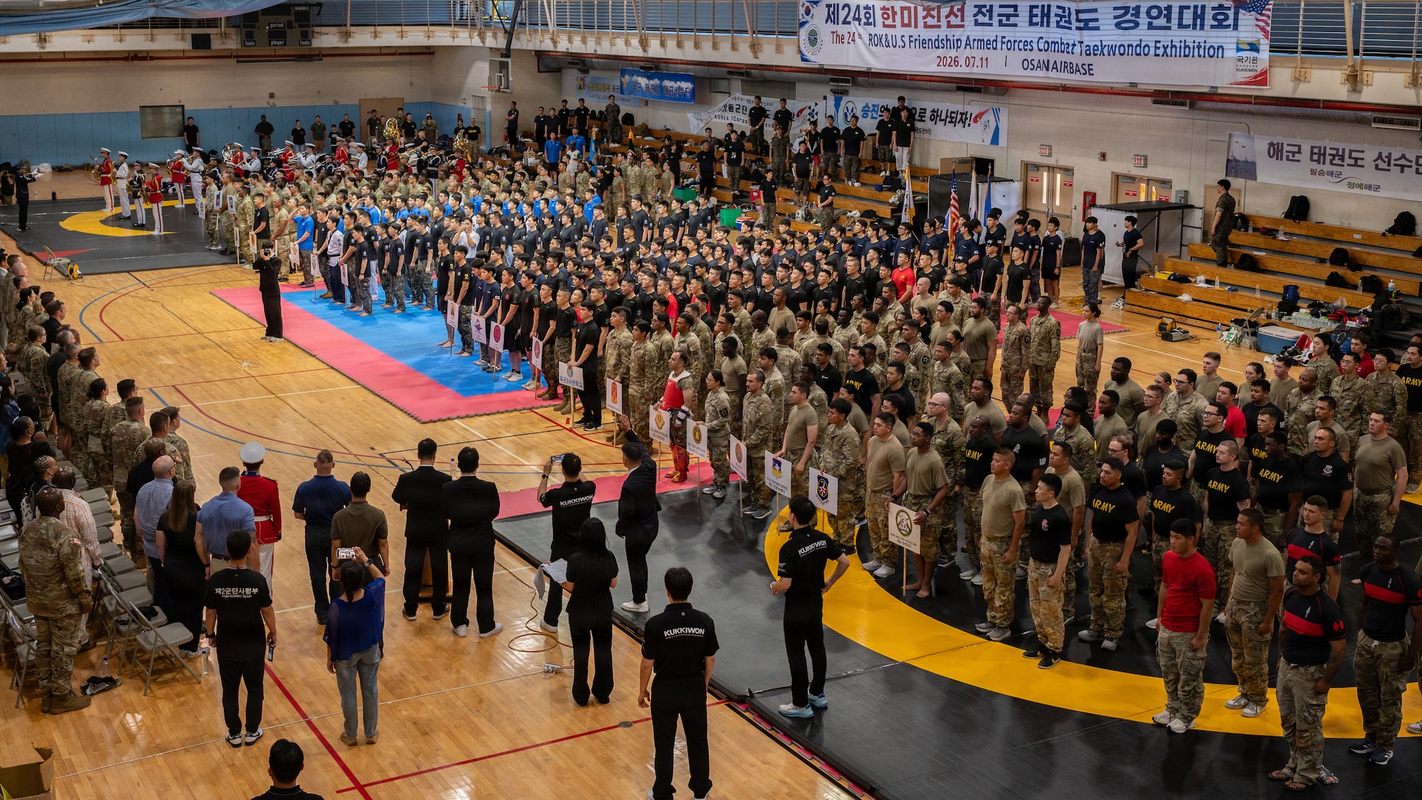 Military service members stand in formation.
