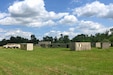 Several shipping containers that have been altered to look like buildings were relocated recently to the grounds of Fort Indiantown Gap's Unmanned Aircraft System Training and Innovation Facility. The mock village allows UAS operators to fly drones around and through simulated buildings in urban environment. (Pennsylvania National Guard photo by Brad Rhen)