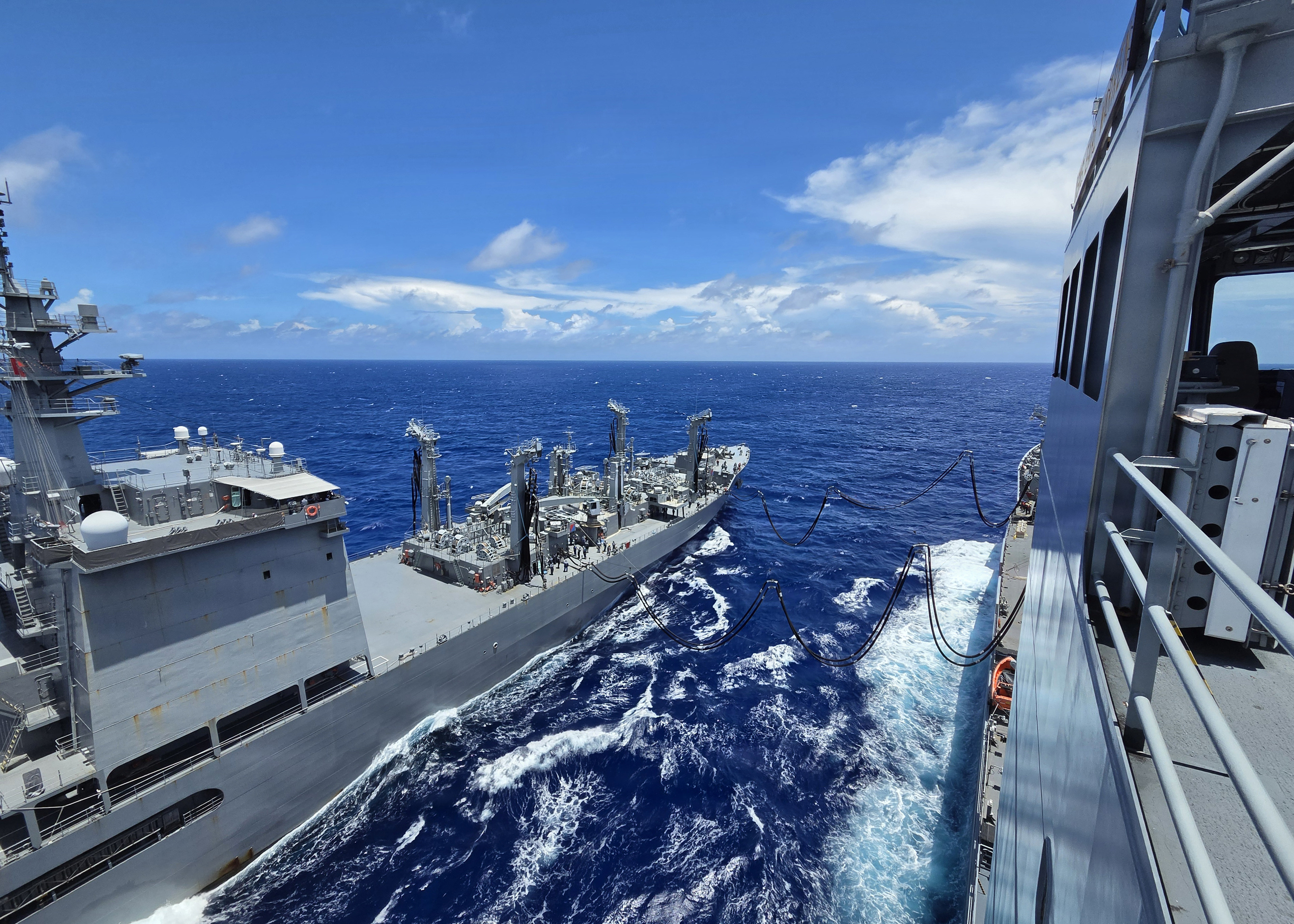 Japan Maritime Self-Defense Force Mashū-class replenishment ship JS Mashū (AOE 425) connects to Military Sealift Command’s John Lewis-class underway replenishment oiler USNS Earl Warren (T-AO 207) during a consolidated cargo replenishment (CONSOL) in the Philippine Sea, June 27, 2026.