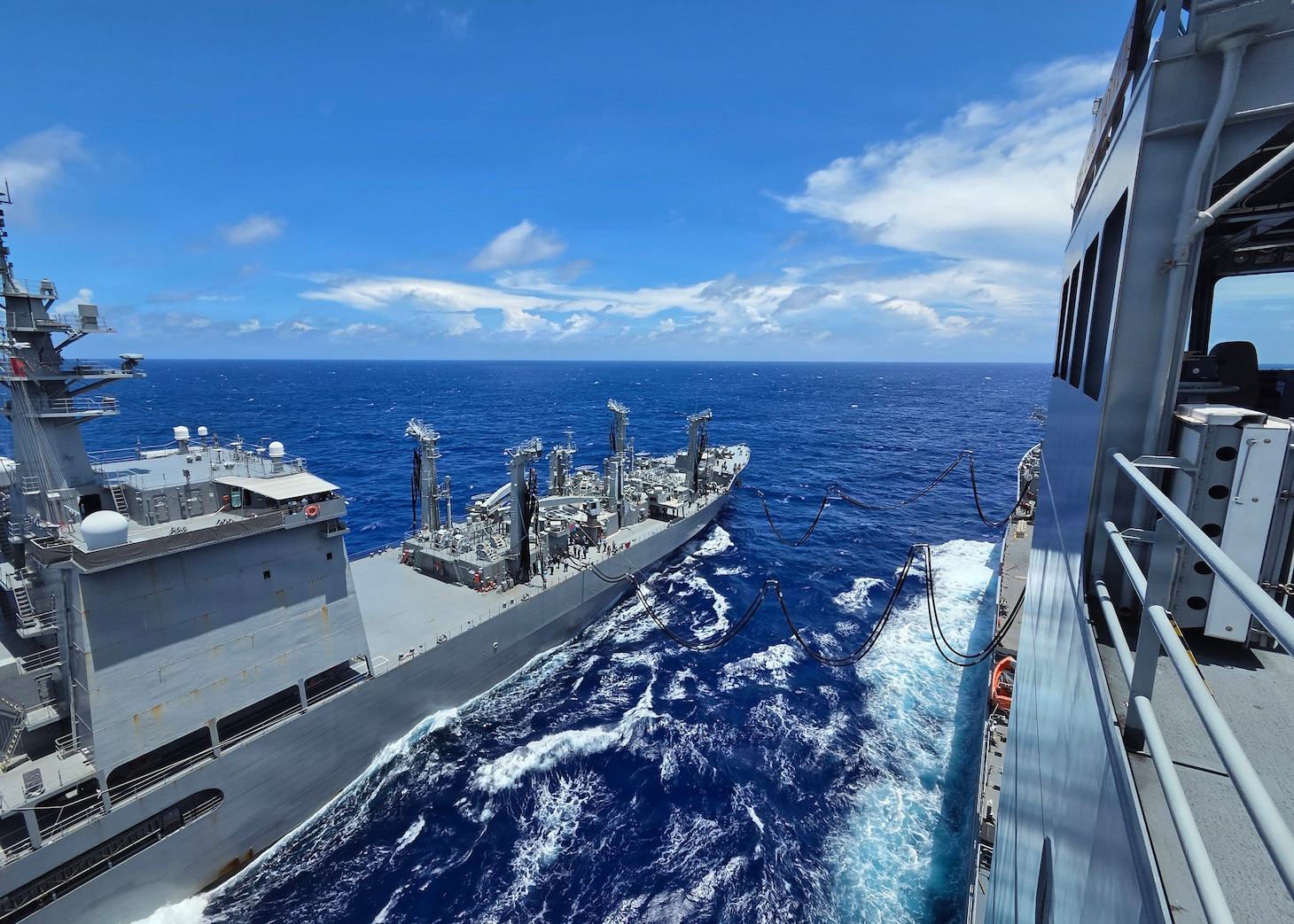 Japan Maritime Self-Defense Force Mashū-class replenishment ship JS Mashū (AOE 425) connects to Military Sealift Command’s John Lewis-class underway replenishment oiler USNS Earl Warren (T-AO 207) during a consolidated cargo replenishment (CONSOL) in the Philippine Sea, June 27, 2026.