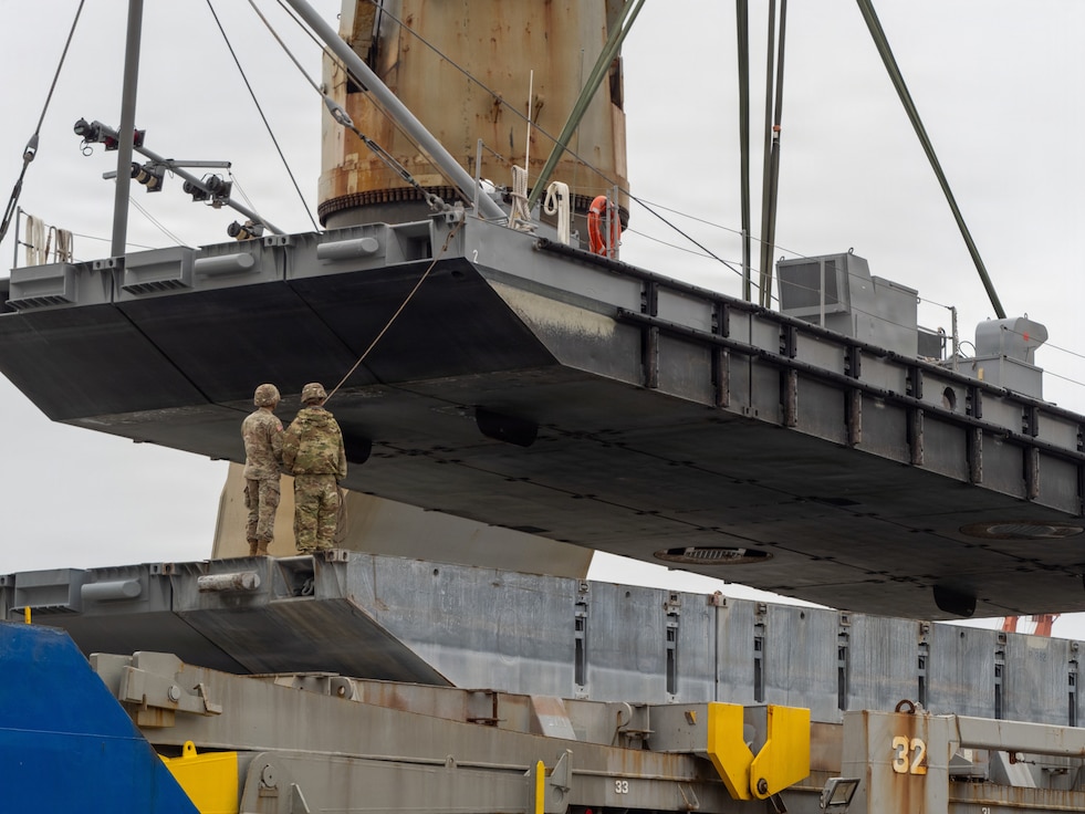 A crane aboard the Ocean Giant vessel lifts a Modular Warping Tug into the water at Pohang Port, South Korea, during CJLOTS 26.