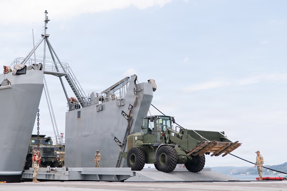 A military 624K wheel loader offloads from a Logistics Support Vessel onto Trident Pier during CJLOTS operations in Pohang, South Korea.
