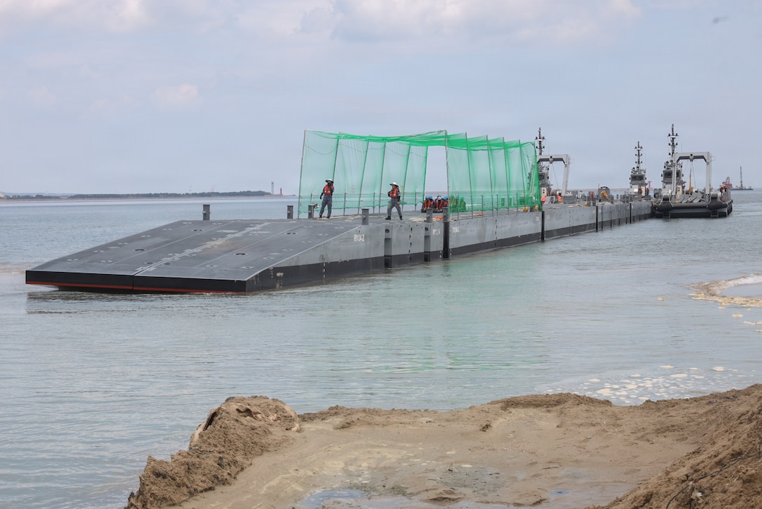 Republic of Korea service members operate on an Improved Navy Lighterage System platform as it conducts a beach stabbing maneuver at Dogu Beach, Pohang, South Korea, during the Combined Joint Logistics Over-the-Shore (CJLOTS) 26 exercise.