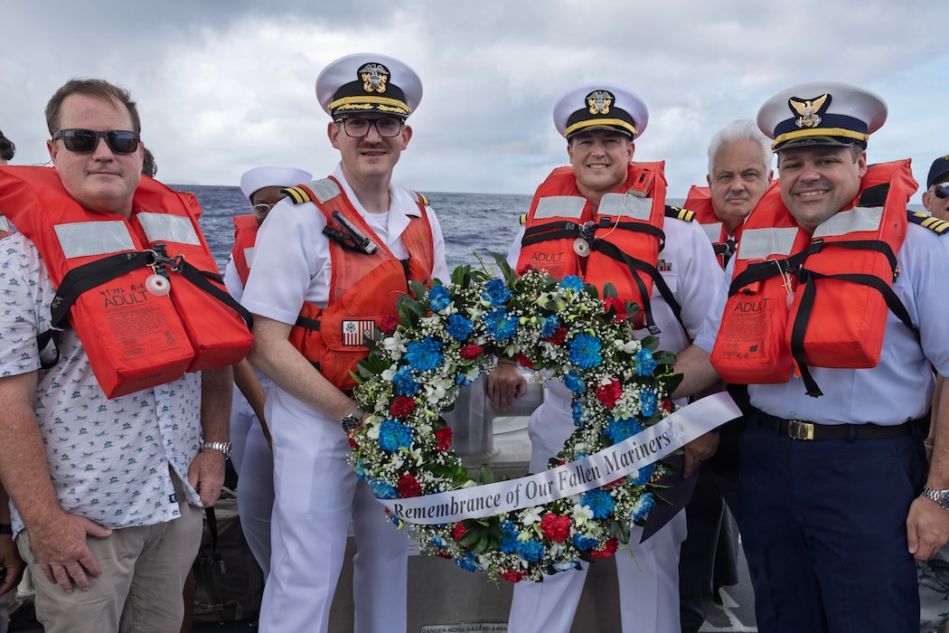Service members and civilians participate in a wreath laying ceremony off the coast of Naval Base Guam during a National Maritime Day commemoration to honor all fallen civilian mariners, May 22, 2026.