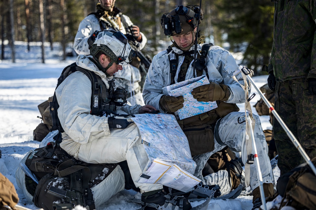 U.S. Marine Corps Capt. Jonathon Scott, right, a company commander with 2nd Battalion, 6th Marine Regiment, 2nd Marine Division, and Swedish army 1st Lt. Eric Haslum, a staff officer with Göta Engineering Regiment, review a map in Rovaniemi, Finland, March 12, 2026. Marines participated in the force-on-force portion of exercise Cold Response 26 alongside Swedish soldiers with Skaraborg Regiment to improve combat readiness and lethality against a free-thinking adversary in an unscripted, realistic environment.  A key component of NATO's enhanced vigilance activity Arctic Sentry, exercise Cold Response 26 is a Norwegian-led winter military exercise designed to enhance collective defense capabilities and ensure U.S. readiness to rapidly deploy and seamlessly operate alongside NATO Allies in challenging arctic conditions. (U.S. Marine Corps photo by Staff Sgt. Armando Elizalde)